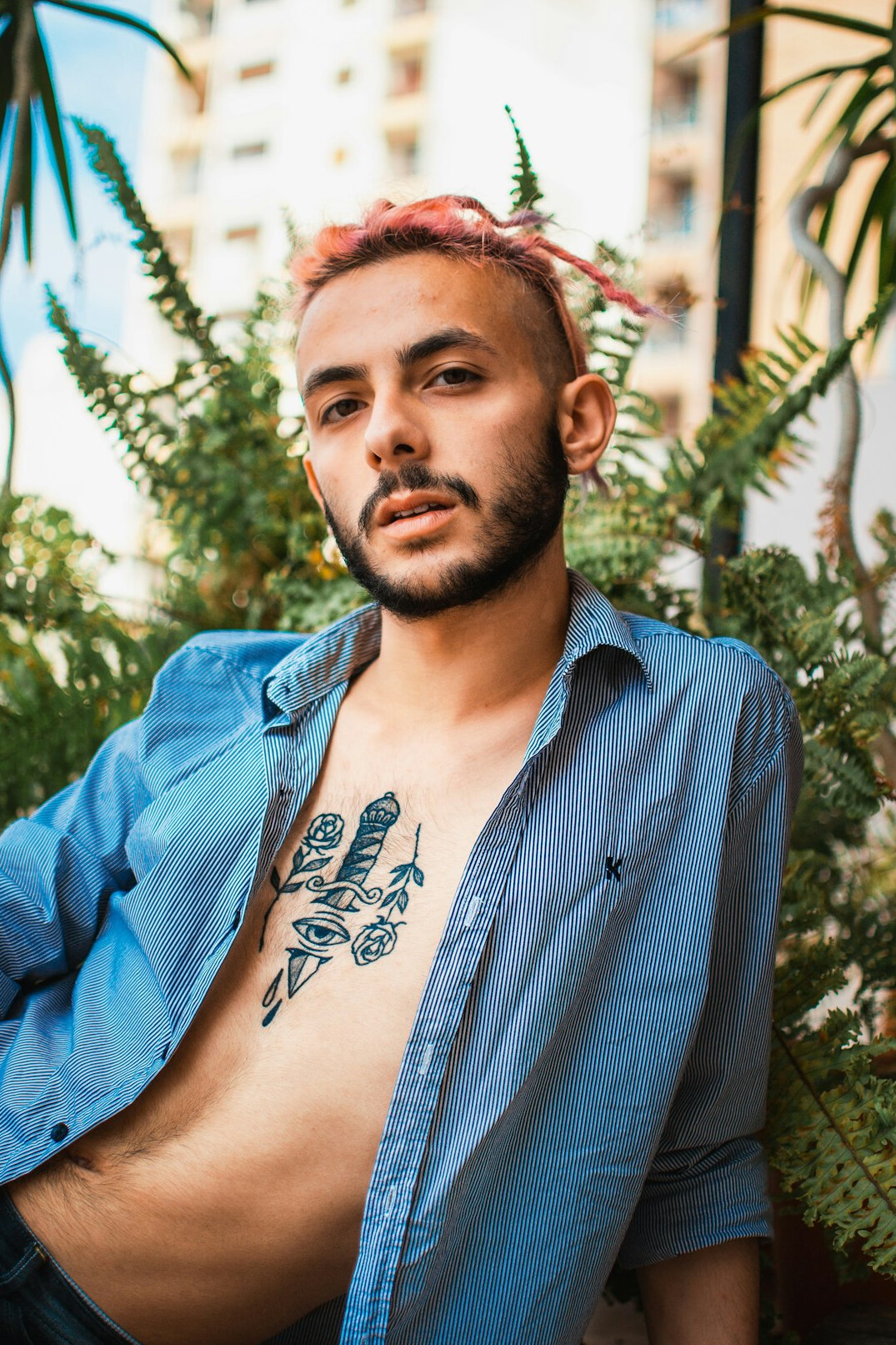 Portrait of a young man with a short beard wearing a shirt
