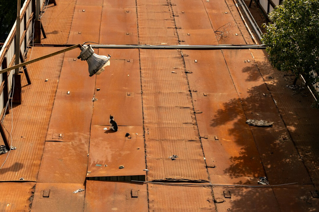 Worker applying protective treatment on a metal surface